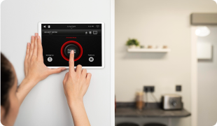 Woman adjusting smart home thermostat using a mobile app for convenient temperature control indoors.